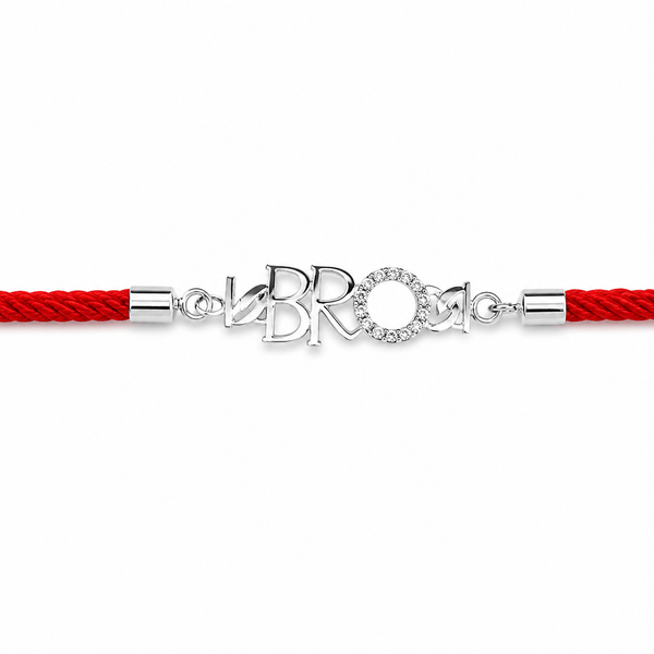 A red braided cord bracelet with a silver-tone central charm spelling 'BRO' in stylized letters, one of which is a circular halo set with small clear stones, shown on a plain white background.